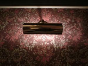 a light fixture hanging from a red wall at Hotel Hyper Noah (Adult Only) in Sakai