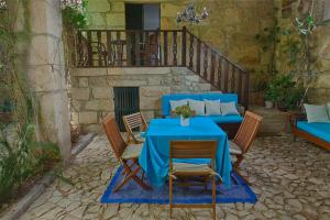 a blue table and chairs on a patio at Casa de Assade in Grimancelos