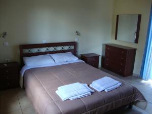 a bedroom with a large bed with two towels on it at Gavdos Princess in Gavdos