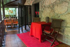 a table with a red table cloth on it in a room at Casa de Assade in Grimancelos