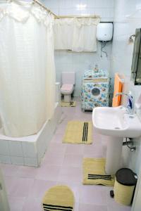 a bathroom with a sink and a toilet and a shower at Grand Museum Guest House in Kafr Abū ʼumaydah