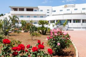 a view of a building with flowers in the foreground at Hotel Scial&igrave; in Vieste