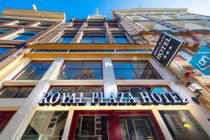 a building with a sign on the side of it at Royal Plaza Hotel Amsterdam in Amsterdam