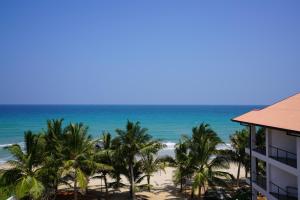 a view of the beach from the balcony at Cardamon Hotel Nilaveli in Nilaveli