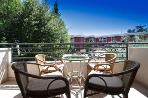 a patio with chairs and a table on a balcony at Captain Apartments in Budva