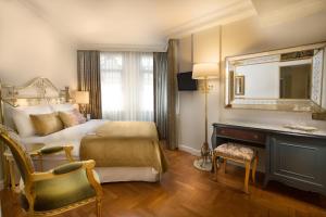 a bedroom with a bed and a desk and a mirror at Valide Sultan Konagi in Istanbul