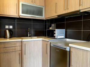 Kuchyň nebo kuchyňský kout v ubytování Mc Queen Rooms & Apartments