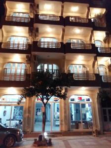 a building with a tree in front of it at Nicea Hotel in Selçuk