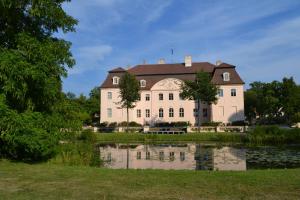 a large building with a pond in front of it at City-Hotel Cottbus in Cottbus