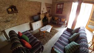 a living room with two couches and a fireplace at Stou Kir Yianni in Omodos