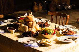 a table topped with plates of food and bowls of food at Kalistine Ethnography House in K'veda Kinch'kha