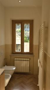 a bathroom with a white sink and a window at Appartamento Nature Il Colle in Marciana