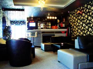 a bar with couches and a fireplace in a room at Max - Mamaia Nord in Mamaia Nord