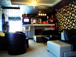 a bar with couches and a fireplace in a room at Max - Mamaia Nord in Mamaia Sat/Năvodari