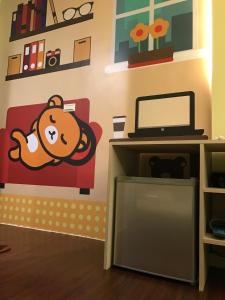 a room with a wall with a monkey on a couch at Fantastic Hostel in Taichung