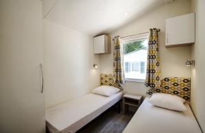 a small room with a bench and a window at Holiday Marina Resort in Grimaud +75 photos