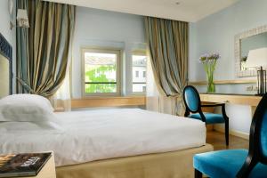 Uma cama ou camas num quarto em FH55 Grand Hotel Palatino