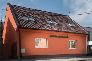 an orange building with the words garden apartments at Garden apartments in Prešov