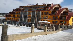 a large building in the snow in front at Apartment in Snow Plaza 49 in Bakuriani