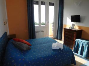 A bed or beds in a room at Baia delle Favole Affittacamere