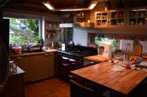 a kitchen with a stove and a wooden counter top at B&B Bij MoeMee in Ghent