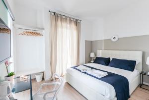 a bedroom with a white bed and blue pillows at Le Dune di Villa Diana in Vasto