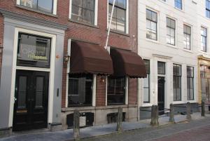 a store with brown awnings in front of a building at Zala's B&B in Utrecht