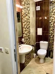 a bathroom with a toilet and a sink at Beach Apartments Pomorie in Pomorie