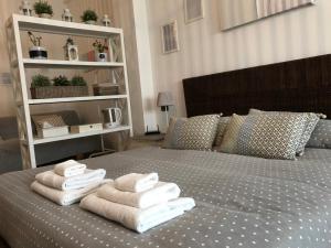 a bedroom with a bed with towels on it at RighePois in Reggio di Calabria