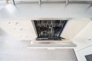 an overhead view of a kitchen with white cabinets at Ruterra Apartment Charles Bridge in Prague