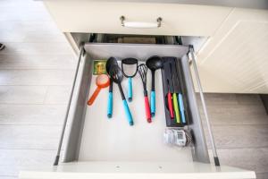 a drawer full of utensils in a cabinet at Ruterra Apartment Charles Bridge in Prague