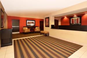 a lobby with red walls and a waiting room at Extended Stay America Suites - Rochester - North in Rochester