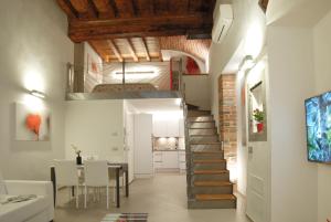 フィレンツェにあるラ ペルラ ア パラッツォ ヴェッキオのテーブルとダイニングルームのある客室内の階段