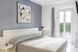 a white bedroom with a bed and a window at Little Aurelius in Rome
