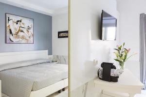 a bedroom with a white bed and a mirror at Little Aurelius in Rome +29 photos