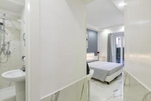a bedroom with a bed and a sink and a mirror at Little Aurelius in Rome