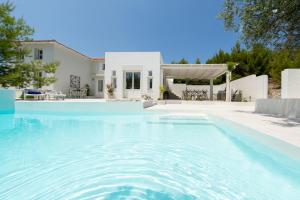 a swimming pool in front of a house at Anemolia Villas with private pools near the most beautiful beaches of Alonissos in Alonnisos