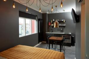 a bedroom with a bed and a table and a kitchen at 105 - A Townhouse Hotel in Reykjavík