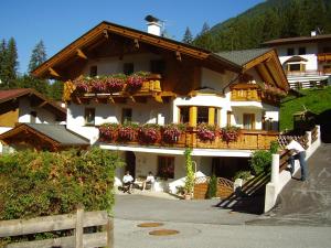 a large building with flower boxes on the balconies at Haus Bergzauber in Neustift im Stubaital