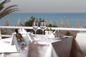a white table with wine glasses and napkins at Circeo Park Hotel in San Felice Circeo