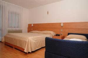 Postel nebo postele na pokoji v ubytování Hotel Cima Tosa
