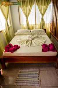 A bed or beds in a room at Poor Man's Paradise Lodge