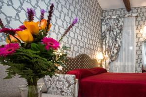 Posteľ alebo postele v izbe v ubytovaní Hotel Ca' Nobile Corner