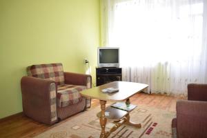 a living room with a table and a tv at Apartment on Gagarina 67 in Rivne