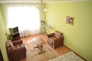 a living room with two chairs and a television at Apartment on Vasylya Chervoniya 67 in Rivne