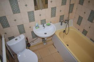 a bathroom with a sink and a toilet and a tub at Apartment on Vasylya Chervoniya 67 in Rivne +22 photos