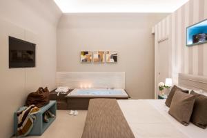 A bed or beds in a room at Villa Gervasio Rooms