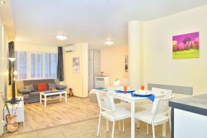 a kitchen and living room with a table and chairs at Central studio #2 in Burgas