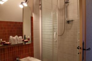 a bathroom with a shower with a sink and a mirror at Hôtel Moderne in Gisors +56 photos