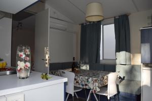 a kitchen with a table and chairs in a kitchen at Villaggio Camping Bosco Selva in Alberobello